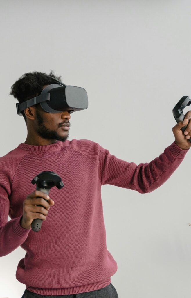 Man wearing VR headset and using controllers in a virtual experience.